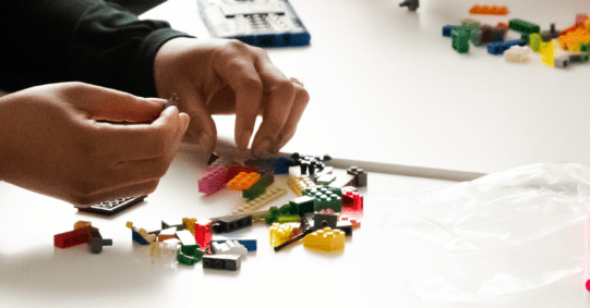 Facilitator guiding a LEGO® Serious Play® workshop with participants.