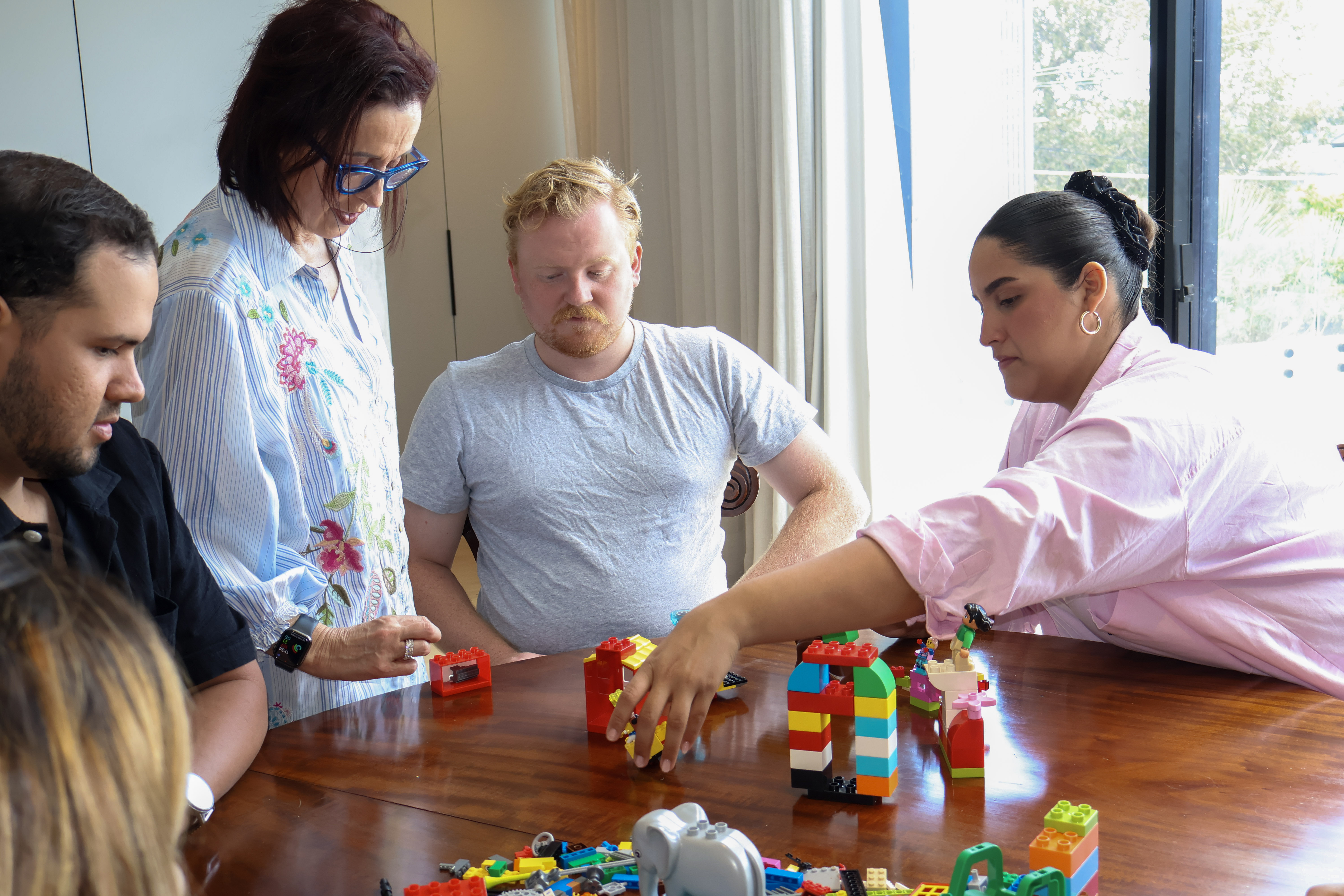A busy office environment visualized with LEGO models, highlighting communication paradoxes.